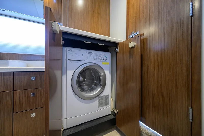 Ajac Cruiser Yacht Photos Pics 2015 Cruisers Cantius yacht interior with built-in washing machine in wooden cabinet.