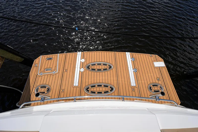 Ajac Cruiser Yacht Photos Pics 2015 Cruisers Cantius yacht deck with wood finish, overlooking water.