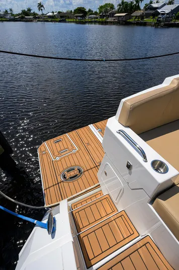 Ajac Cruiser Yacht Photos Pics 2015 Cruisers Cantius boat deck with teak flooring by a serene lake.
