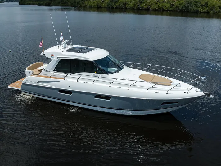 Ajac Cruiser Yacht Photos Pics 2015 Cruisers Cantius yacht cruising on calm water, featuring sleek design and spacious deck.