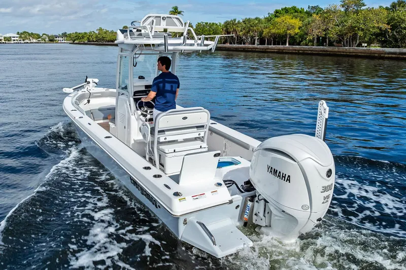  Yacht Photos Pics 2023 Everglades 243 Center Console boat cruising on a scenic waterway.