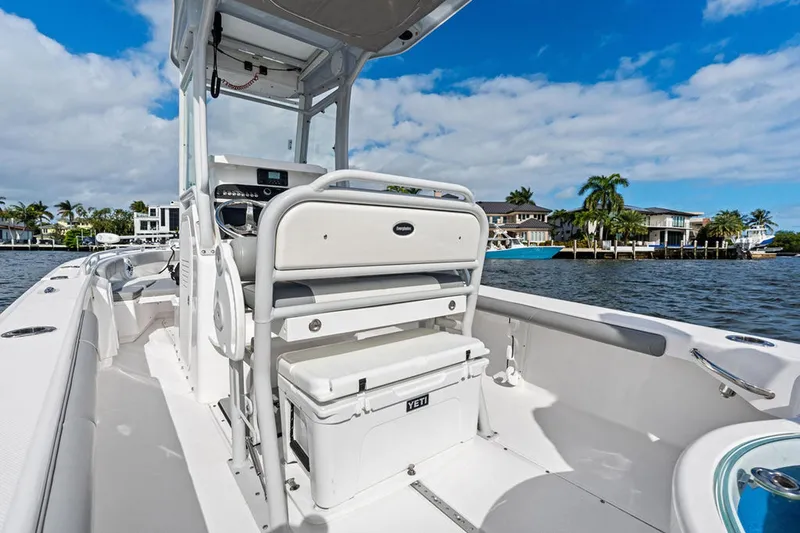  Yacht Photos Pics 2023 Everglades 243 Center Console boat on water, featuring spacious deck and modern design.