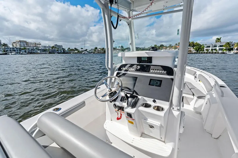  Yacht Photos Pics 2023 Everglades 243 Center Console boat on water, featuring modern helm and controls.