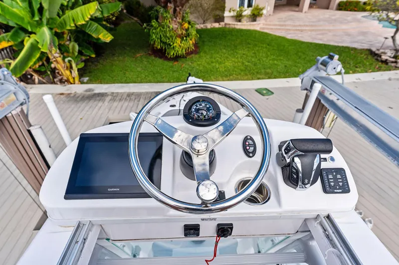  Yacht Photos Pics 2023 Everglades 243 Center Console boat helm with Garmin display and controls.