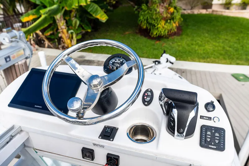  Yacht Photos Pics 2023 Everglades 243 Center Console boat helm with steering wheel and controls.
