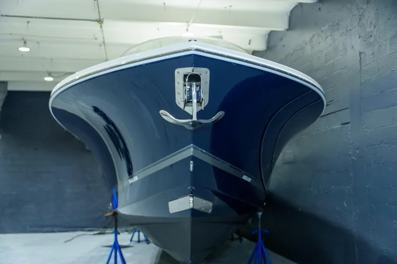  Yacht Photos Pics 2023 Regulator 28 boat in indoor storage, showcasing sleek blue hull design.
