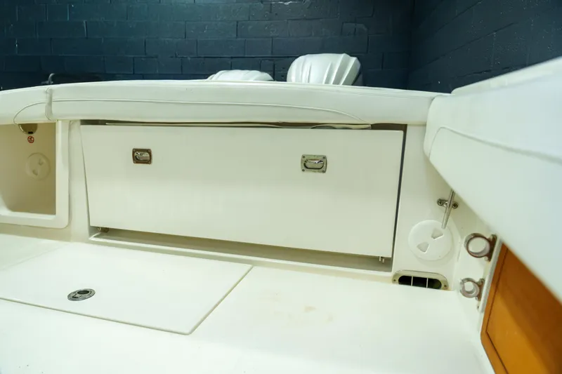  Yacht Photos Pics 2023 Regulator 28 boat interior with white seating and storage compartment.