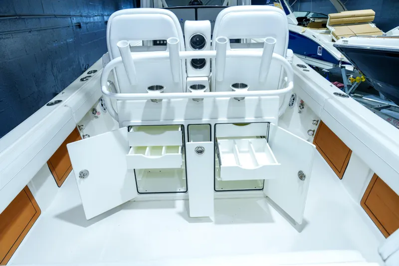  Yacht Photos Pics 2023 Regulator 28 boat interior with open storage compartments and rod holders.