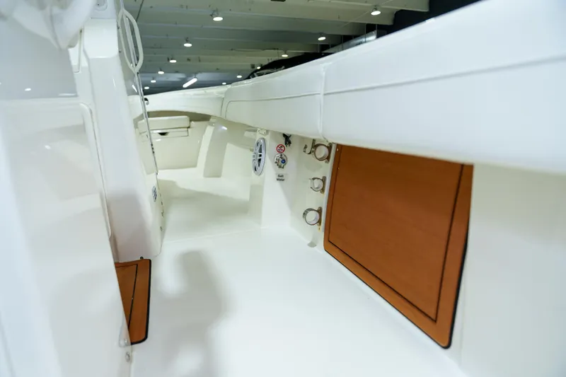  Yacht Photos Pics 2023 Regulator 28 boat interior, showcasing sleek white design and wood accents.