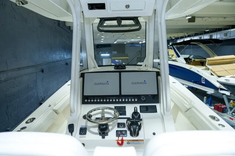  Yacht Photos Pics 2023 Regulator 28 boat dashboard with Garmin navigation system in showroom.