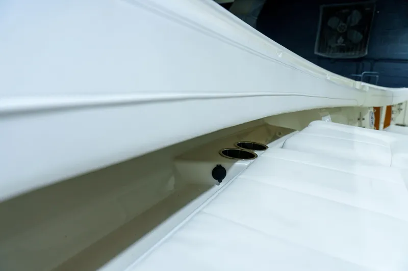  Yacht Photos Pics 2023 Regulator 28 boat interior with white seating and cup holders.