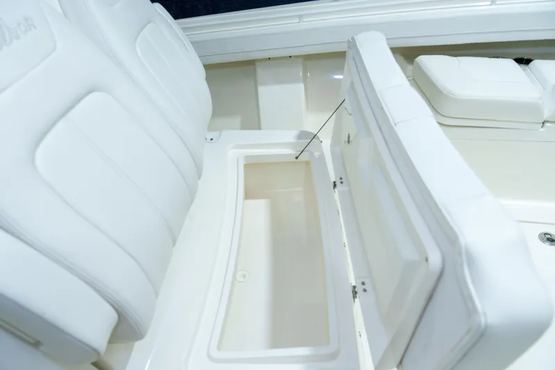  Yacht Photos Pics 2023 Regulator 28 boat interior with open storage compartment and white seating.