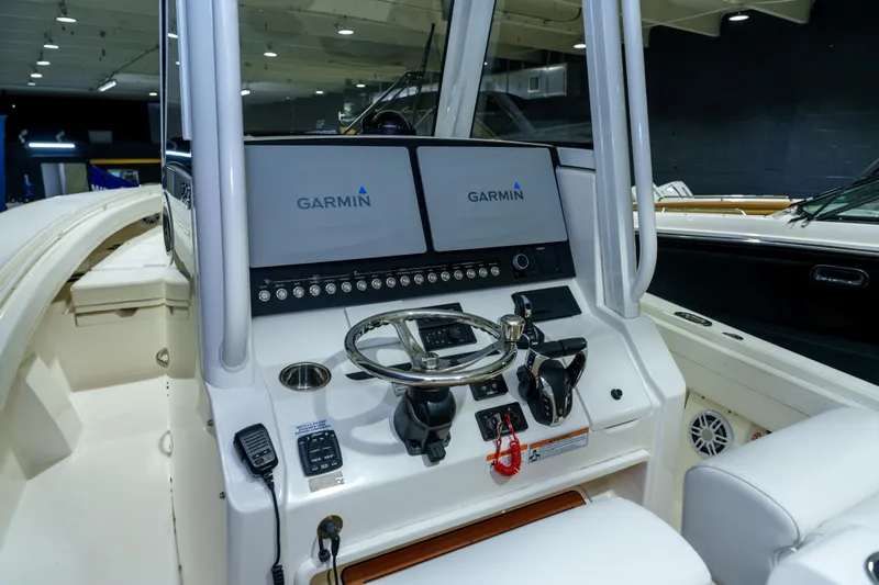  Yacht Photos Pics 2023 Regulator 28 boat dashboard with Garmin navigation system and steering wheel.
