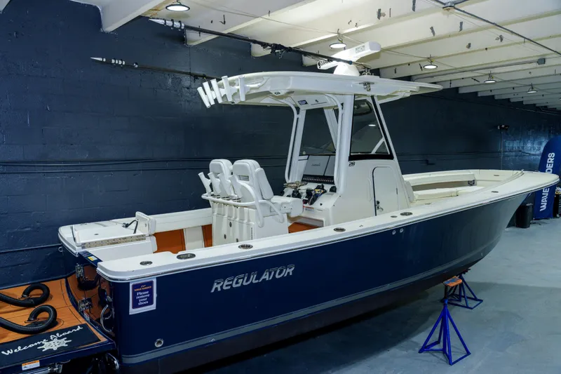  Yacht Photos Pics 2023 Regulator 28 boat displayed indoors, featuring sleek design and modern amenities.
