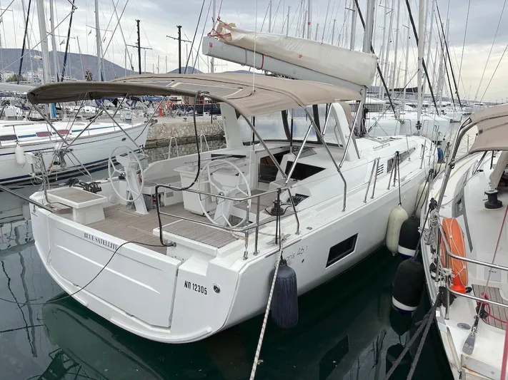 Blue Satellite Yacht Photos Pics 2019 Beneteau Oceanis 46.1 yacht docked in marina, featuring dual steering wheels.