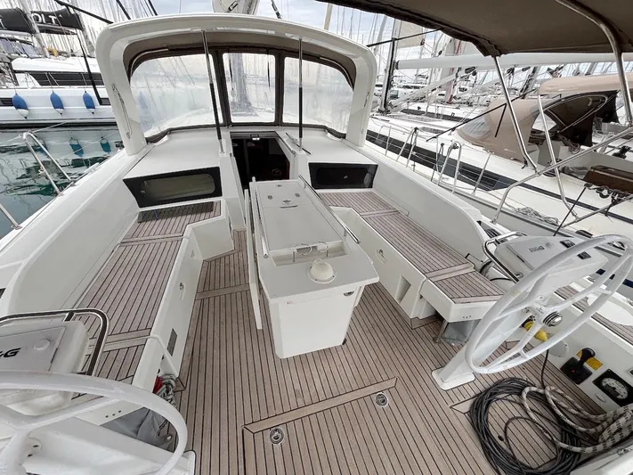 Blue Satellite Yacht Photos Pics 2019 Beneteau Oceanis 46.1 yacht cockpit with teak flooring and dual steering wheels.