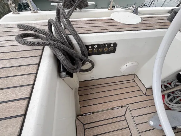 Blue Satellite Yacht Photos Pics Cockpit of 2019 Beneteau Oceanis 46.1 with teak flooring and coiled ropes.