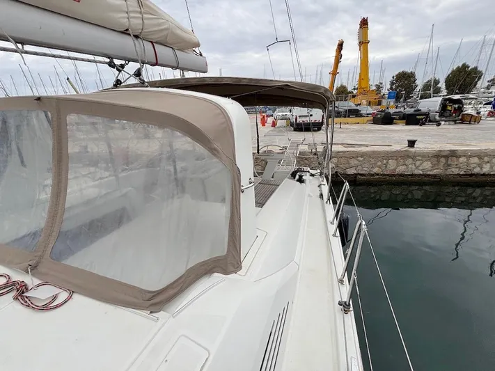 Blue Satellite Yacht Photos Pics Beneteau Oceanis 46.1 sailboat docked at marina, 2019 model, side view.