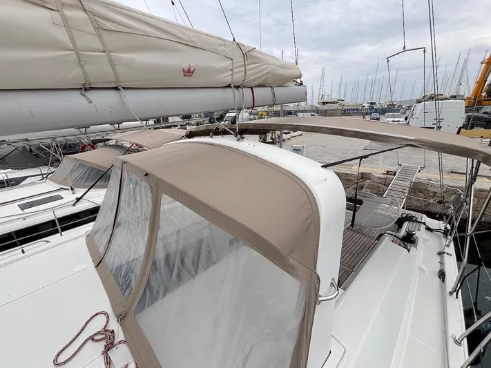 Blue Satellite Yacht Photos Pics Beneteau Oceanis 46.1 sailboat, 2019 model, docked with beige canopy and visible mast.