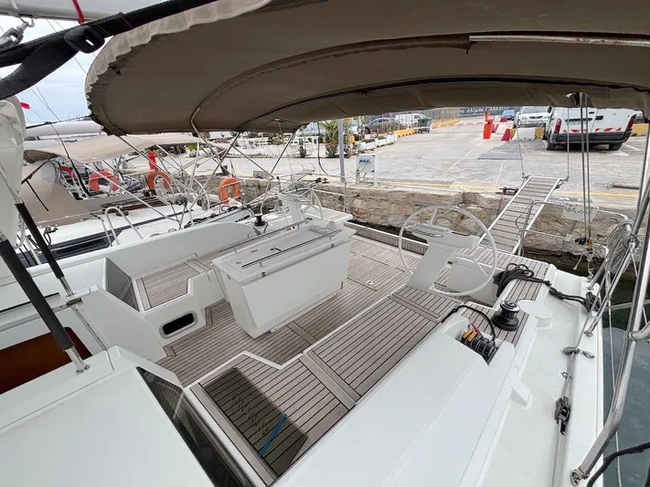 Blue Satellite Yacht Photos Pics 2019 Beneteau Oceanis 46.1 yacht cockpit with dual steering wheels and teak decking.