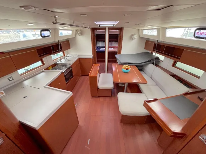 Blue Satellite Yacht Photos Pics Interior of 2019 Beneteau Oceanis 46.1 yacht with modern kitchen and dining area.