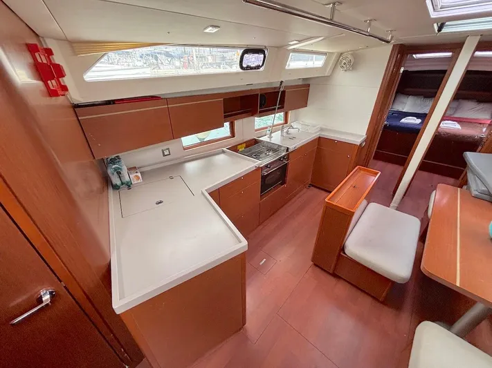 Blue Satellite Yacht Photos Pics Interior of 2019 Beneteau Oceanis 46.1 yacht, featuring a modern kitchen and dining area.