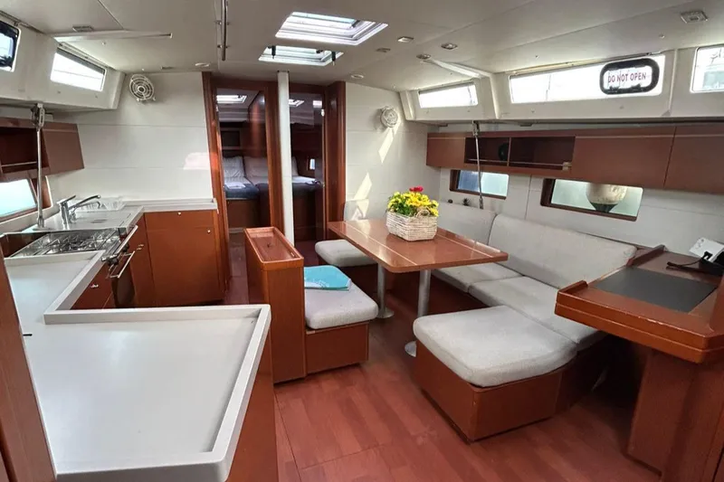 Blue Satellite Yacht Photos Pics Spacious interior of 2019 Beneteau Oceanis 46.1 yacht with modern kitchen and dining area.