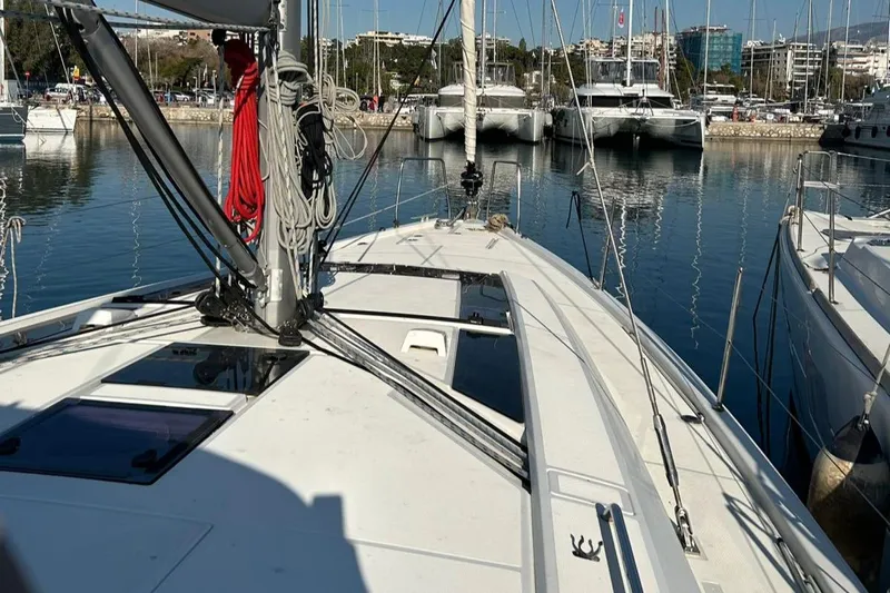 Blue Satellite Yacht Photos Pics 2019 Beneteau Oceanis 46.1 sailboat docked in a marina, surrounded by other boats.