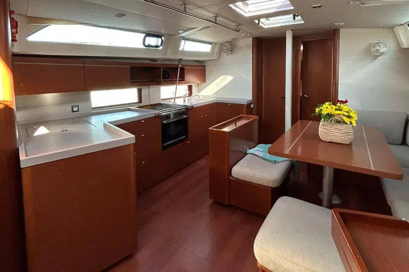 Blue Satellite Yacht Photos Pics Interior of 2019 Beneteau Oceanis 46.1 yacht with modern kitchen and dining area.