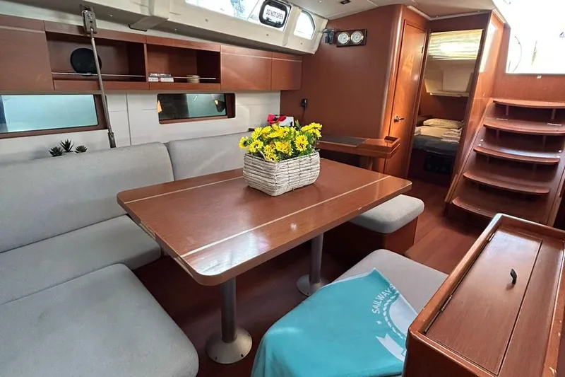 Blue Satellite Yacht Photos Pics Interior of 2019 Beneteau Oceanis 46.1 yacht with dining area and cozy seating.