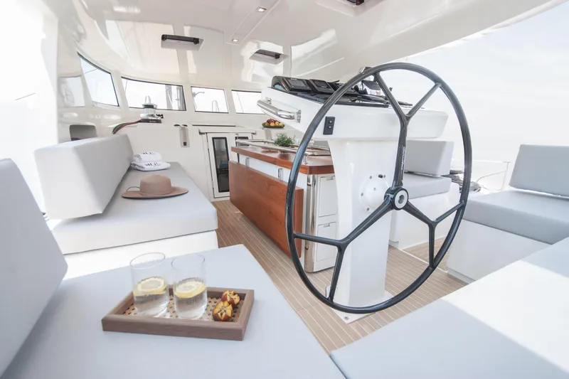 Savoir Faire Yacht Photos Pics Luxurious interior of 2025 MCP Yachts GLOBAL EXP 68 with modern helm and seating area.