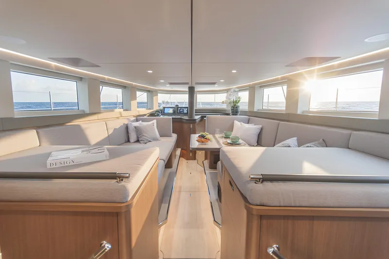 Savoir Faire Yacht Photos Pics Luxurious interior of 2025 MCP Yachts GLOBAL EXP 68 with elegant seating and ocean view.