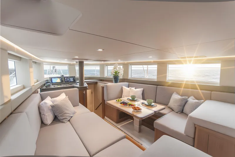 Savoir Faire Yacht Photos Pics Luxurious interior of 2025 MCP Yachts GLOBAL EXP 68 with elegant seating and ocean view.