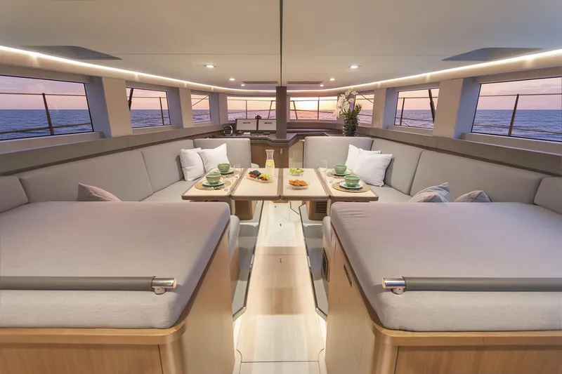 Savoir Faire Yacht Photos Pics Luxurious interior of 2025 MCP Yachts GLOBAL EXP 68 with elegant seating and ocean view.