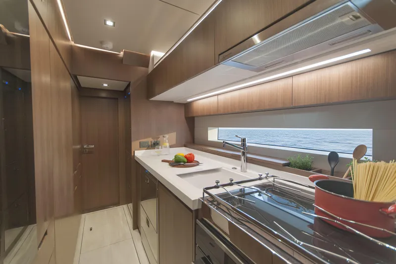 Savoir Faire Yacht Photos Pics Luxurious kitchen interior of 2025 MCP Yachts GLOBAL EXP 68 with ocean view.
