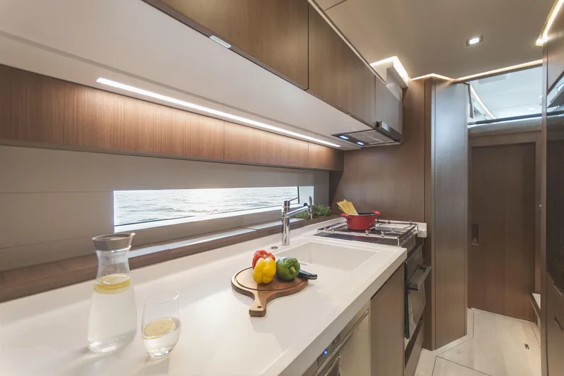 Savoir Faire Yacht Photos Pics Modern kitchen interior of 2025 MCP Yachts GLOBAL EXP 68, featuring sleek design and ocean view.