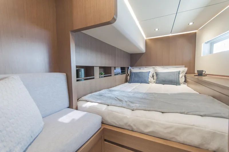 Savoir Faire Yacht Photos Pics Luxurious cabin interior of 2025 MCP Yachts GLOBAL EXP 68 with modern bedding and seating.
