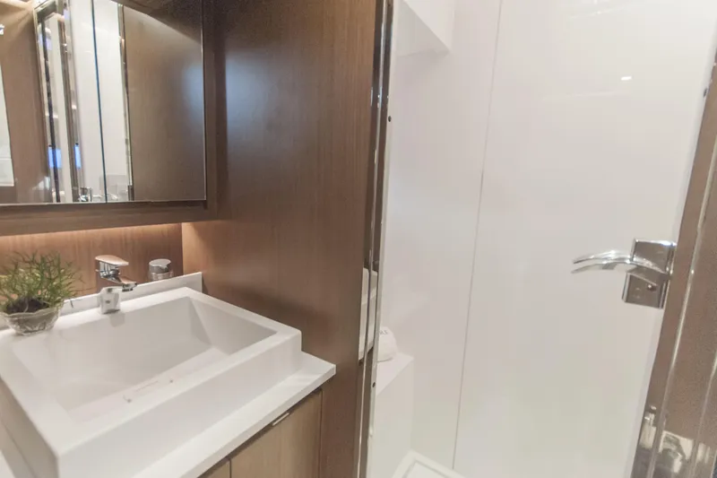 Savoir Faire Yacht Photos Pics Luxurious bathroom interior of 2025 MCP Yachts GLOBAL EXP 68 with modern sink and fixtures.