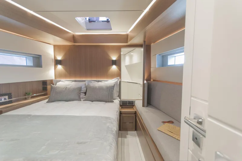 Savoir Faire Yacht Photos Pics Luxurious cabin interior of 2025 MCP Yachts GLOBAL EXP 68 with modern design and cozy bedding.