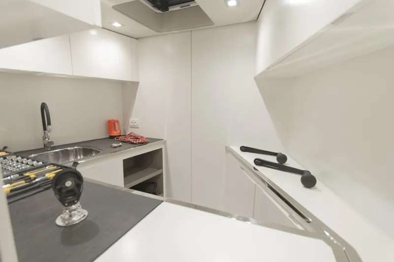 Savoir Faire Yacht Photos Pics Modern kitchen interior of 2025 MCP Yachts GLOBAL EXP 68, featuring sleek design and appliances.