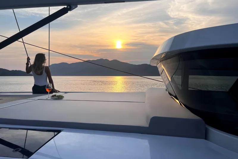 Savoir Faire Yacht Photos Pics Woman enjoying sunset on MCP Yachts GLOBAL EXP 68, 2025 model.