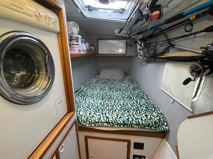 Galileo Yacht Photos Pics Compact cabin interior of 2000 Manta 42 Catamaran with bed and fishing gear.