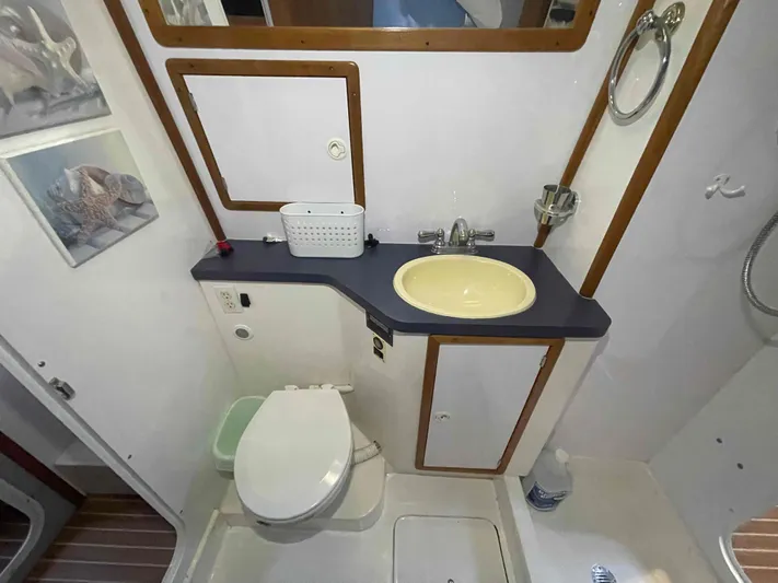 Galileo Yacht Photos Pics Bathroom interior of 2000 Manta 42 Catamaran with sink, toilet, and mirror.