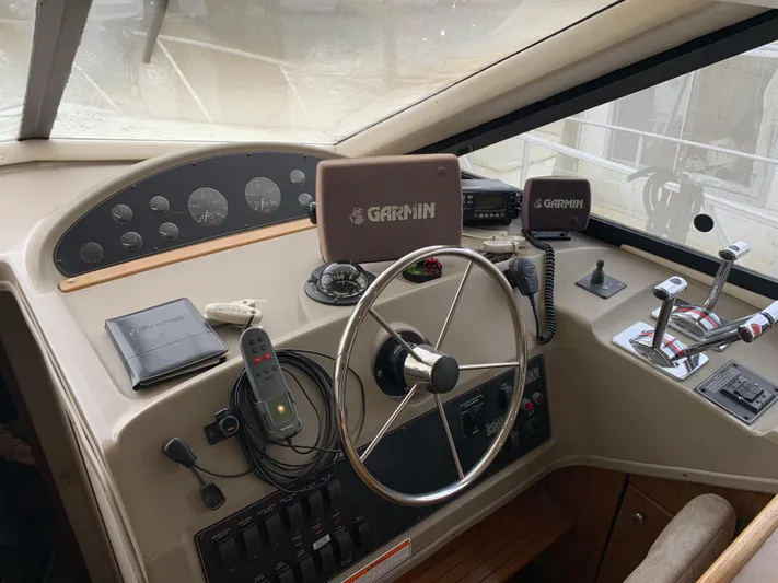  Yacht Photos Pics 2000 Bayliner 3988 helm with Garmin navigation, steering wheel, and control panel.