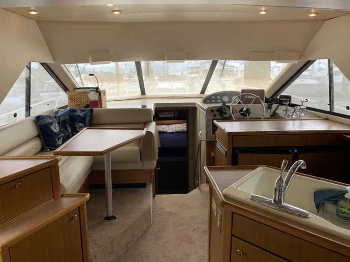  Yacht Photos Pics Interior of 2000 Bayliner 3988 yacht with seating, table, and kitchenette.