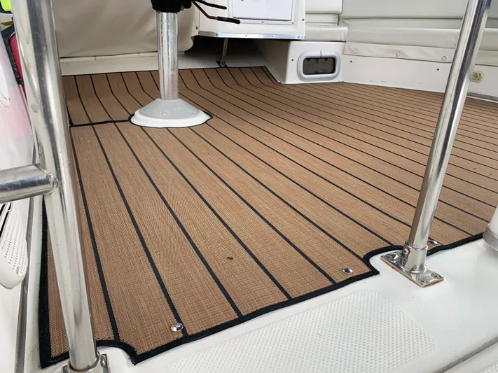  Yacht Photos Pics Bayliner 3988 2000 model boat deck with teak-style flooring and stainless steel railings.