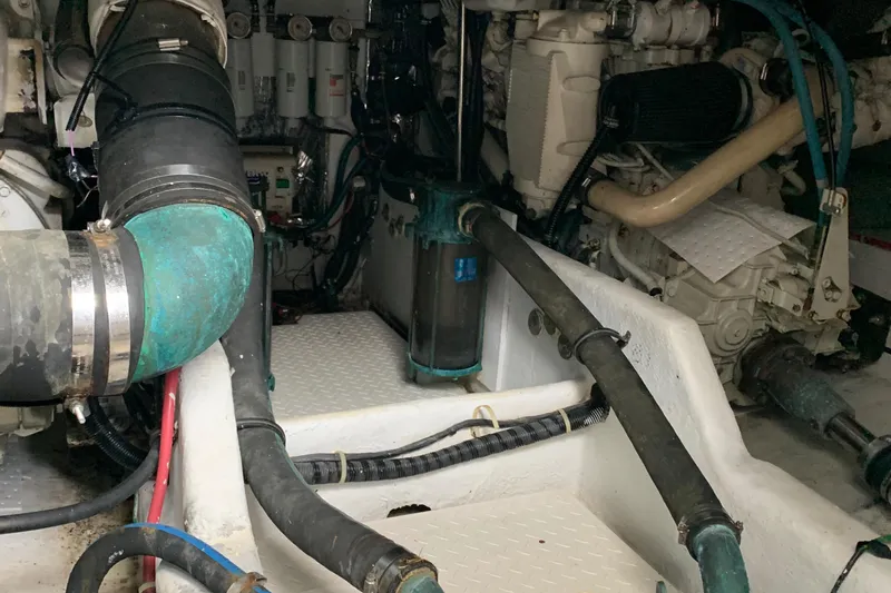  Yacht Photos Pics Engine room of a 2000 Bayliner 3988 boat, showcasing mechanical components and piping.