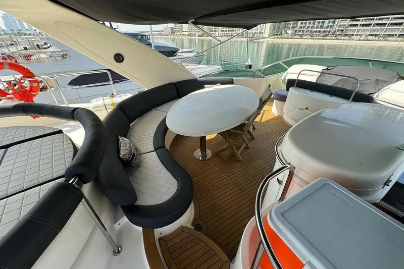  Yacht Photos Pics Luxurious 2003 Azimut 98 Leonardo yacht deck with seating and table, docked at marina.