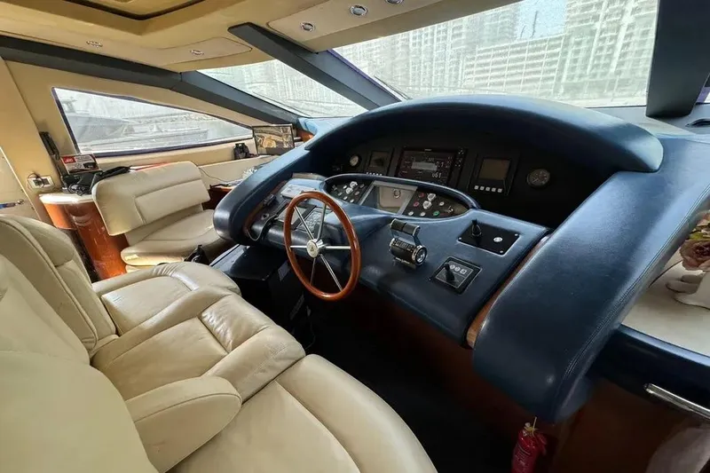  Yacht Photos Pics Luxurious interior of 2003 Azimut 98 Leonardo yacht cockpit with leather seating and control panel.