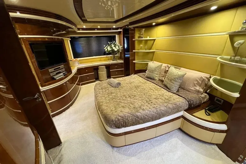  Yacht Photos Pics Luxurious bedroom interior of 2003 Azimut 98 Leonardo yacht with elegant decor and modern amenities.